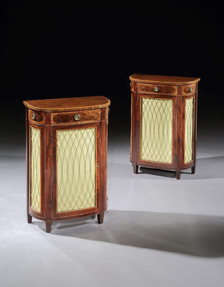 A small pair of mahogany d-shaped side cabinets